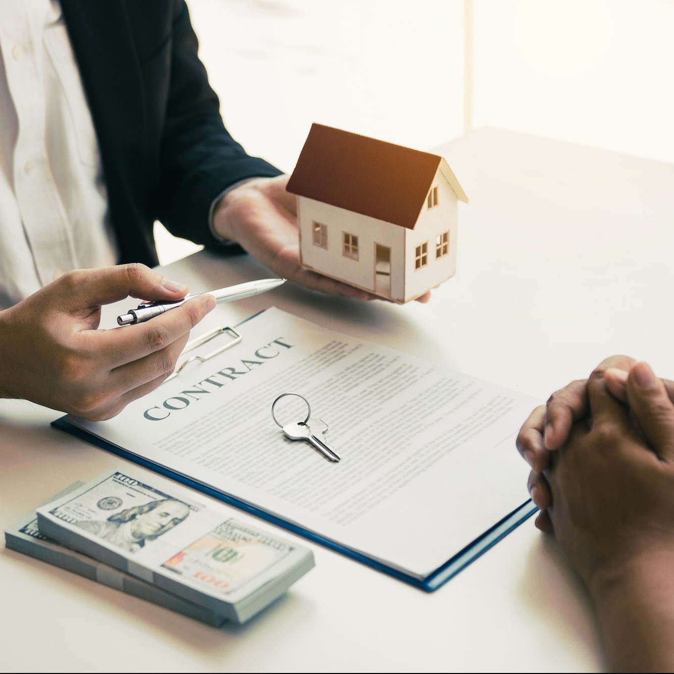 Business people home sales broker is using a pen pointing to the house